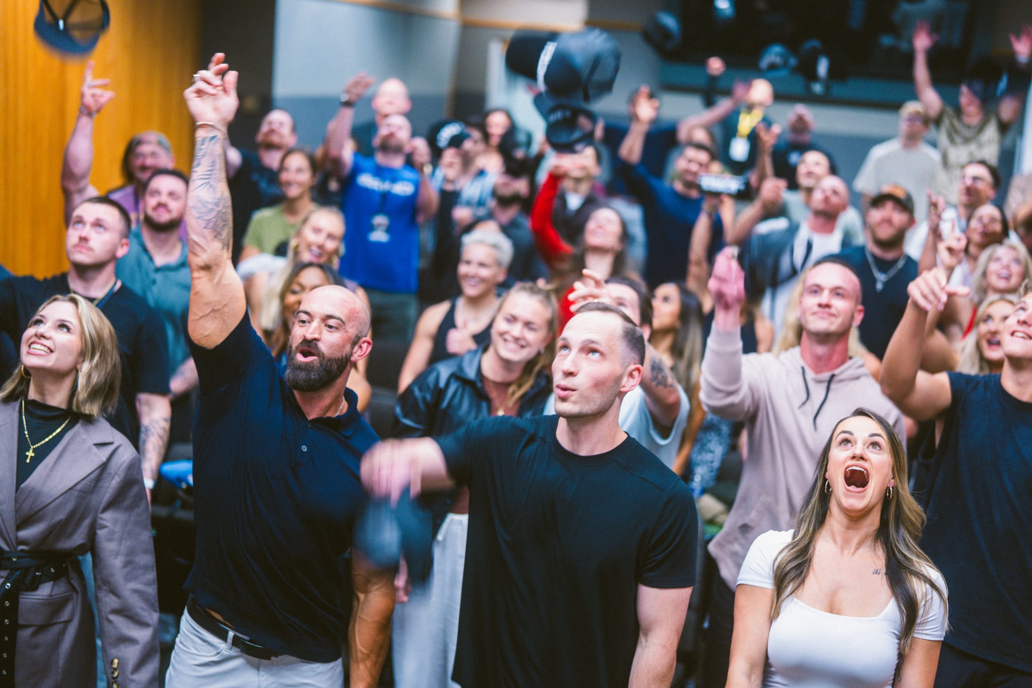A crowd of coaches cheering with fists up